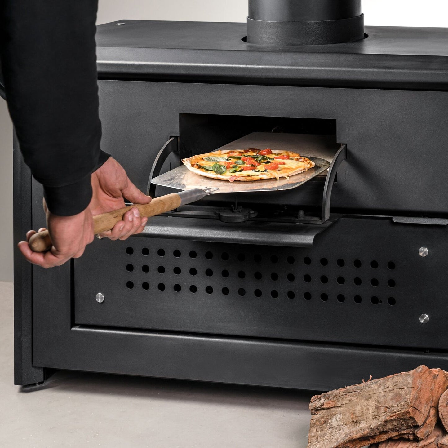 Baking pizza in a traditional wood oven - The Woodfired Co