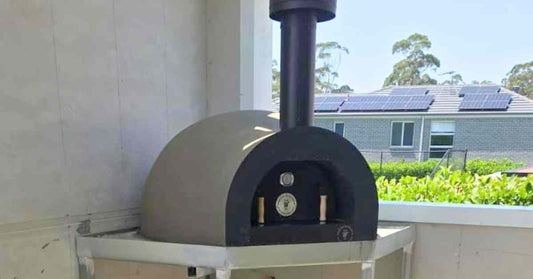 Wood fired oven installed in background
