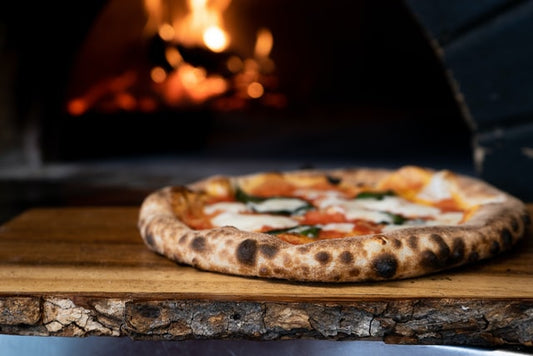 Well cooked pizza baked in fire oven - The Woodfired Co