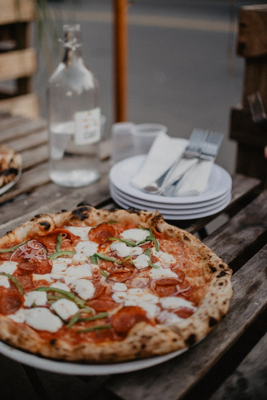 Pizza with cheese and tomatoes - The Woodfired Co