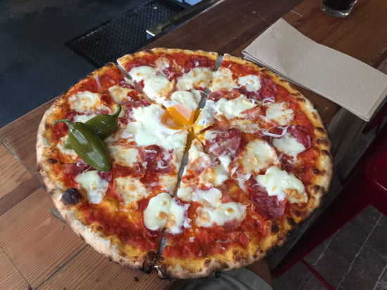 Sliced cheesy pizza - The Woodfired Co