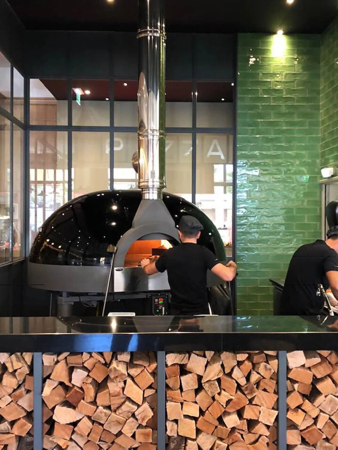 Black fire oven with tons of chopped woods - The Woodfired Co